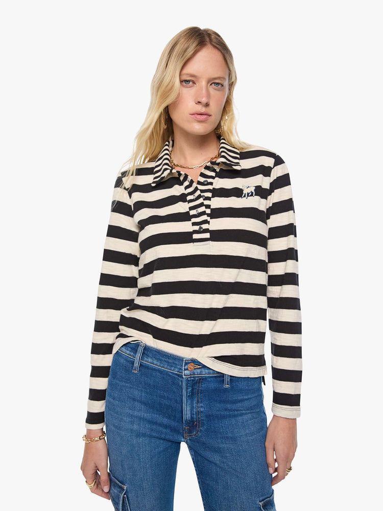 Front view of a woman in black and cream stripes long sleeve top features a fuzzy lamb patch on the chest.