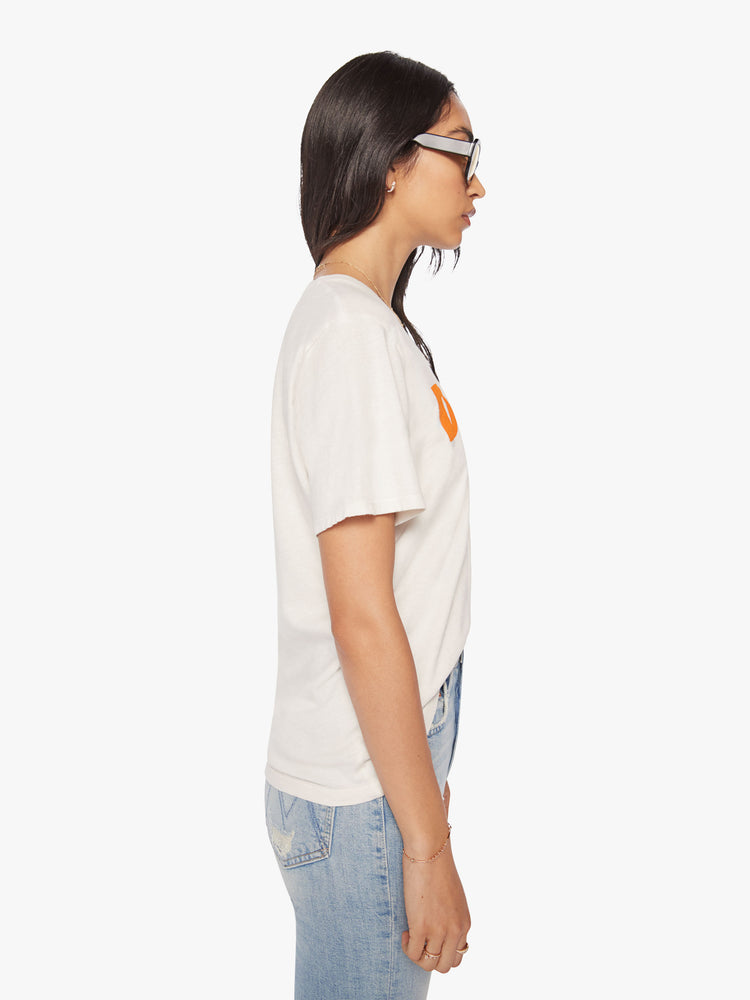 Side view of a woman off-white crewneck tee paying tribute to David Bowie Moonlight Tour, with orange text graphic.