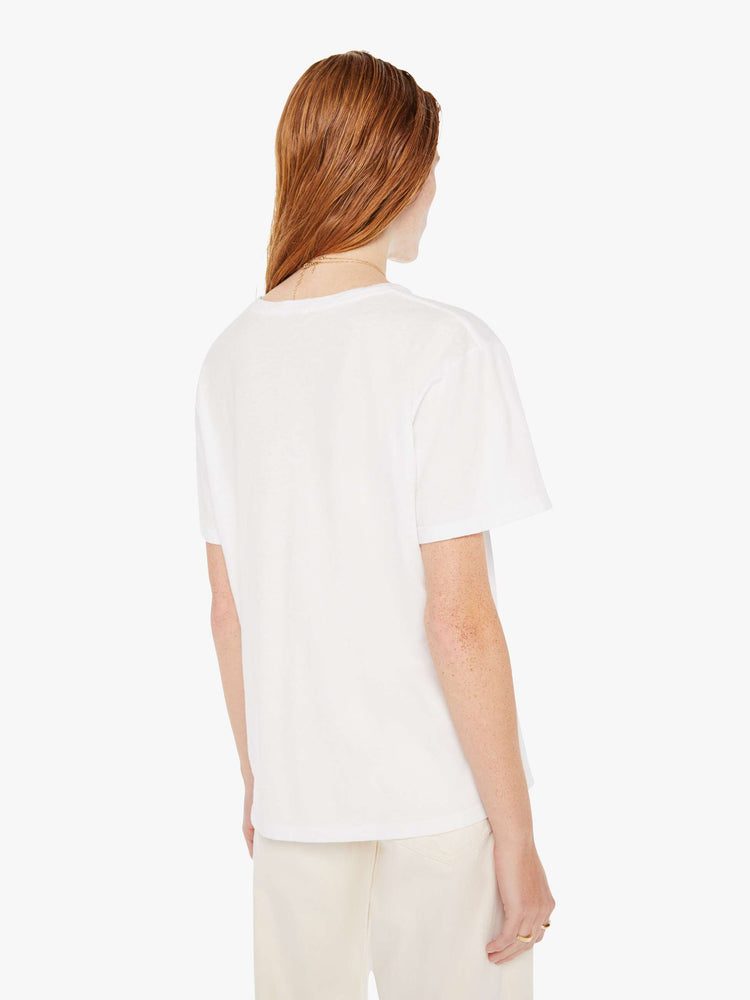 A back view of a woman wearing an oversized white crew neck tee.