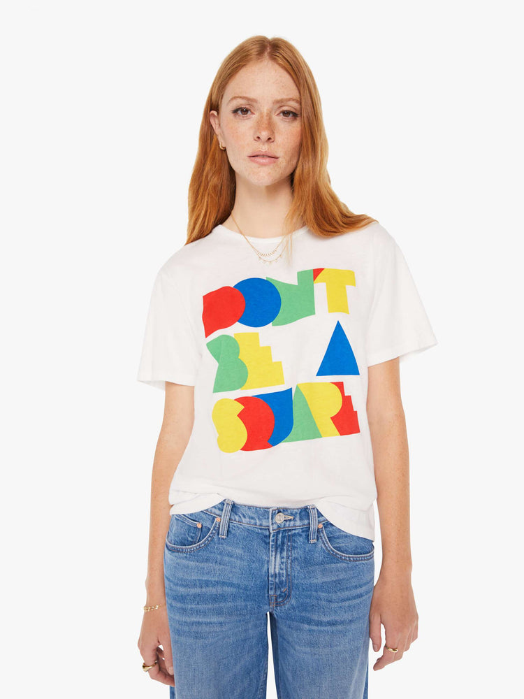 Front view of a woman white oversized crewneck tee with overlapping shades of red, blue, green and yellow on front.
