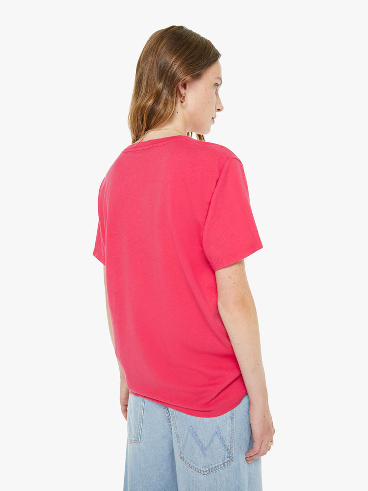 Back view of a woman in a hot pink tee features a subtle message from MOTHER in oversized yellow block text on the front.