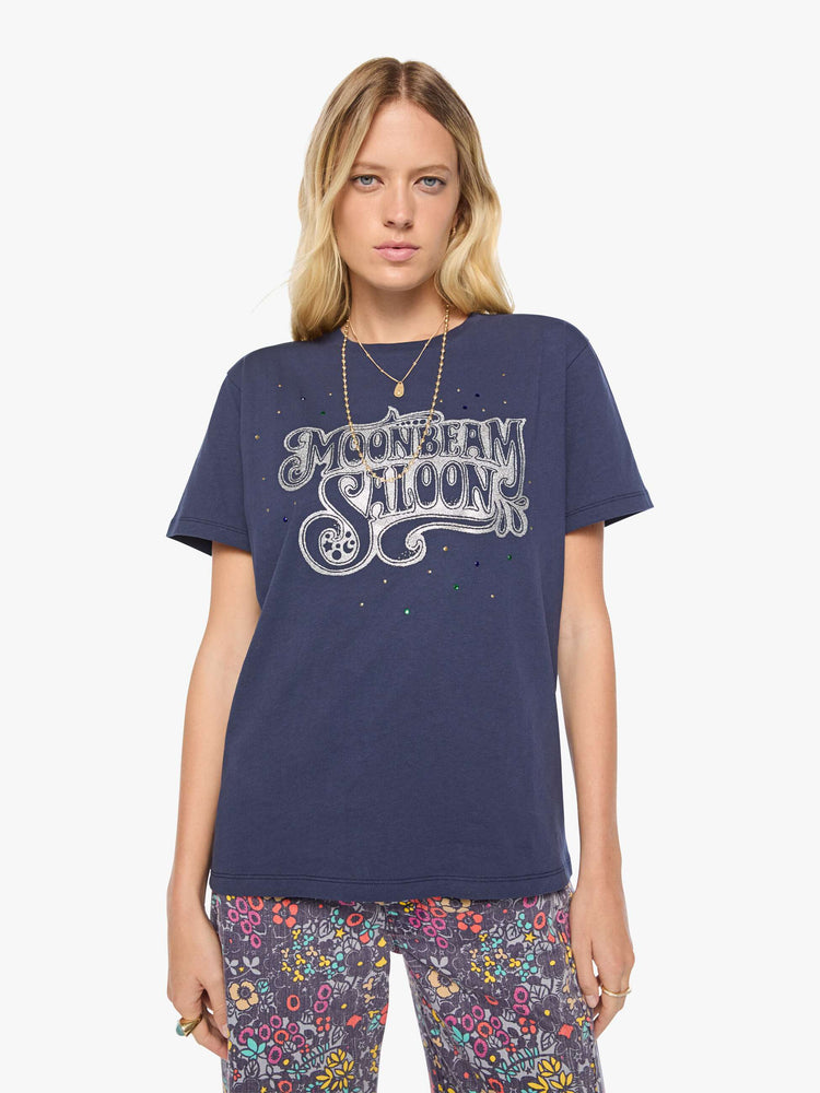 Front view of a woman in dark navy tee with a faded text graphic in white on the front, rhinestone details and MOTHER's name in studs on the back.