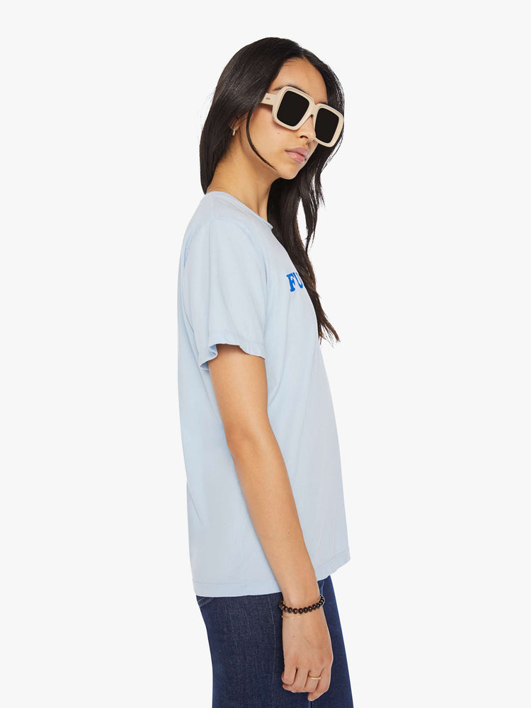 Side view of a womens light blue crew neck tee featuring an oversized fit and a blue graphic.