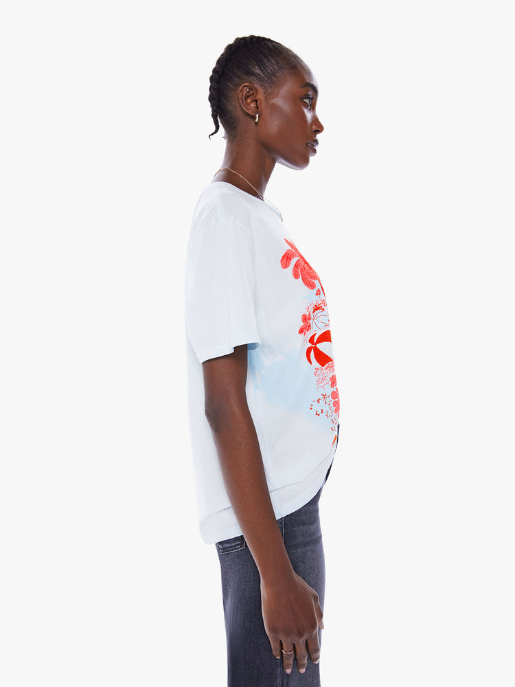 Side view of a woman crewneck tee with an oversized fit in a semi-sheer off-white tee features a bright red graphic.