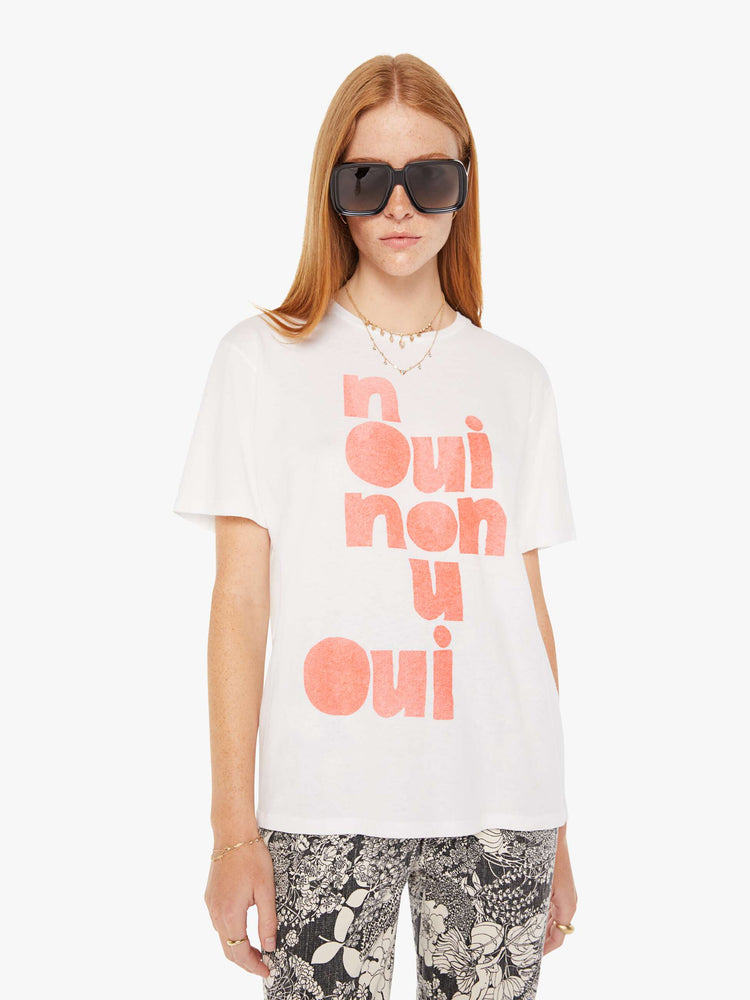 Front view of a womens white crew neck tee featuring an oversized fit and a large red graphic reading OUI NON.