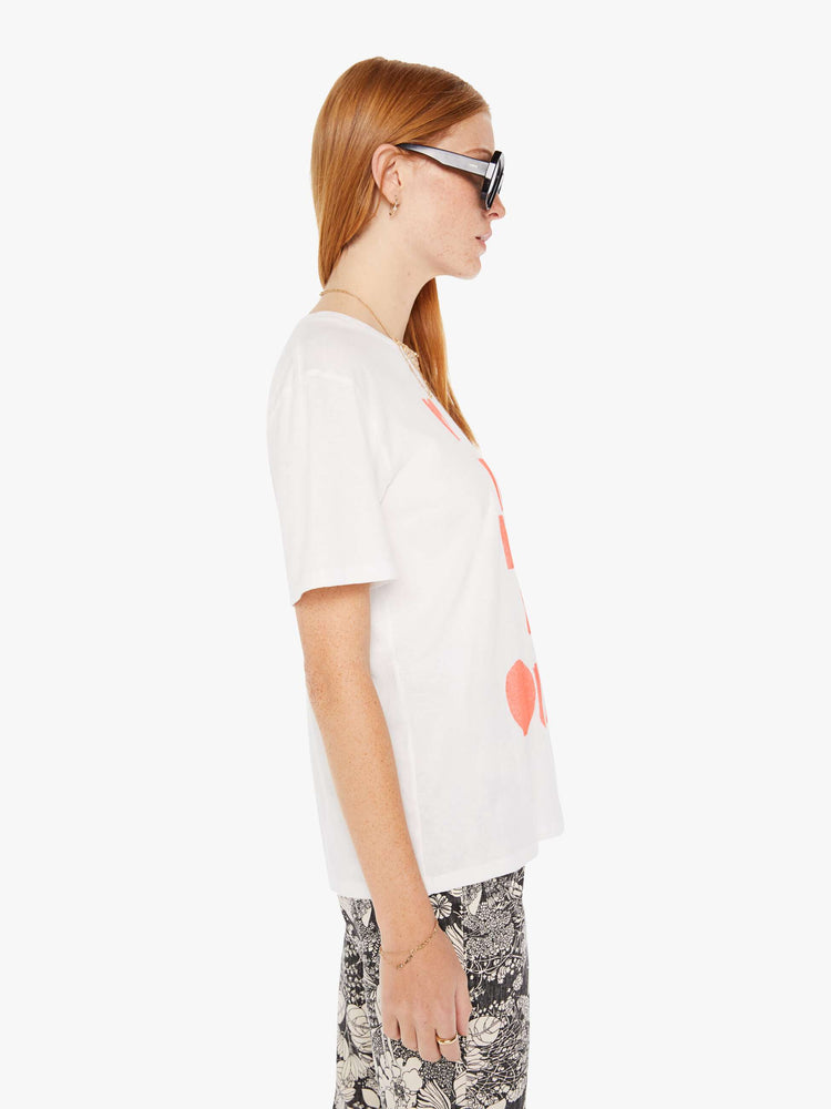 Side view of a womens white crew neck tee featuring an oversized fit and a large red graphic reading OUI NON.