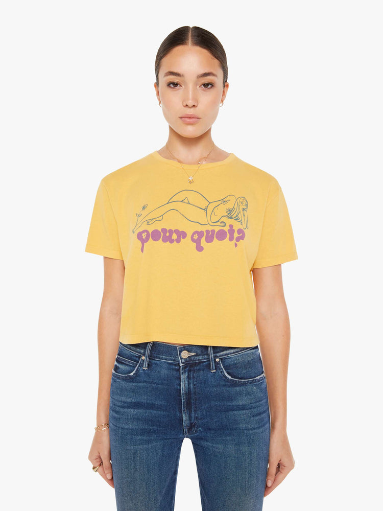 Front view of a womens yellow crew neck tee featuring a boxy, cropped fit and a graphic of a woman and "pour quoi?" in purple.