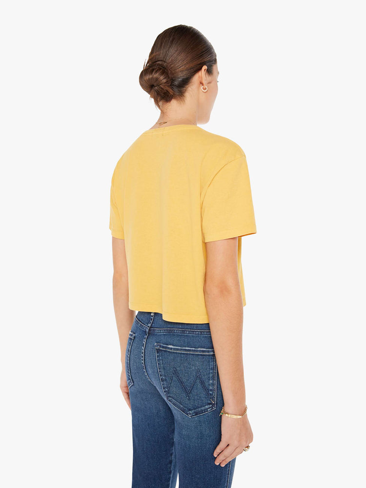 Back view of a womens yellow crew neck tee featuring a boxy, cropped fit.