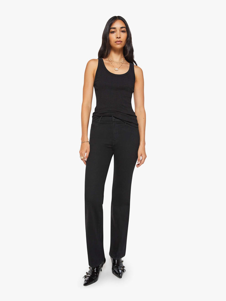 Full body view of a woman in black  tank with wide straps and a slightly shrunken fit. 