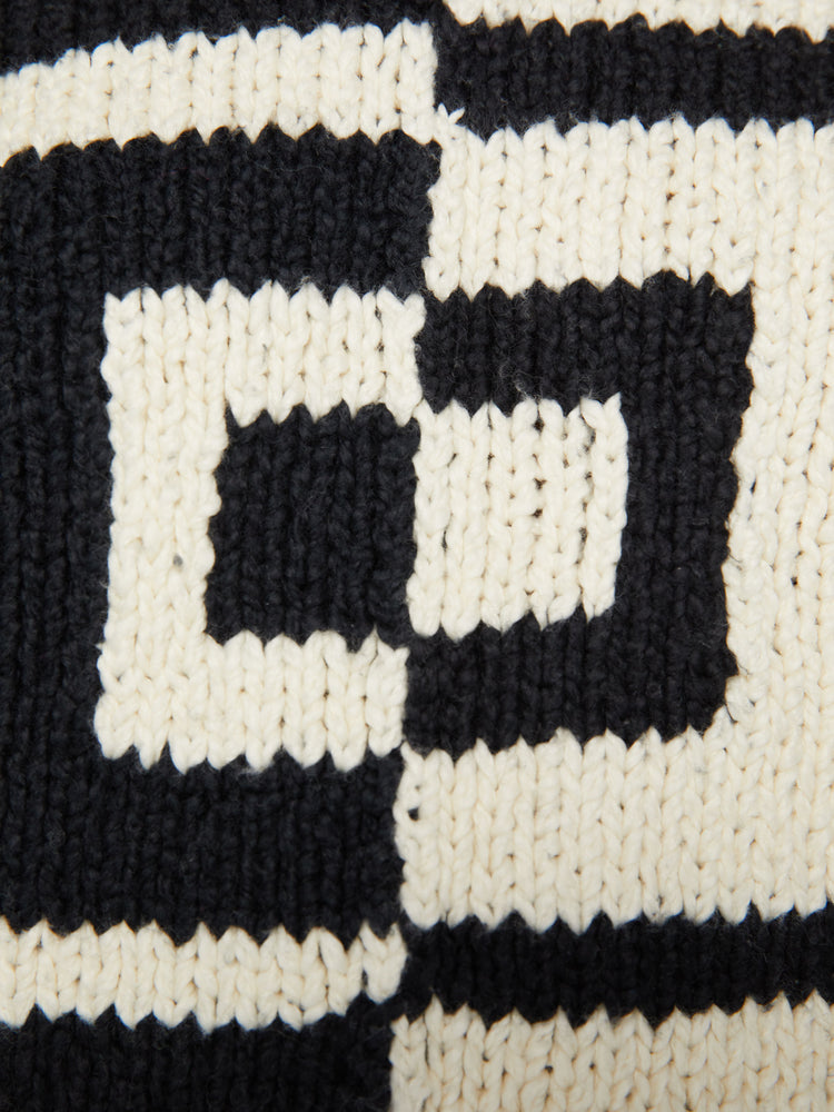 Swatch view of a woman sweater with drop shoulders, long sleeves and a slightly cropped hem in a black and white design that's split down in the middle.