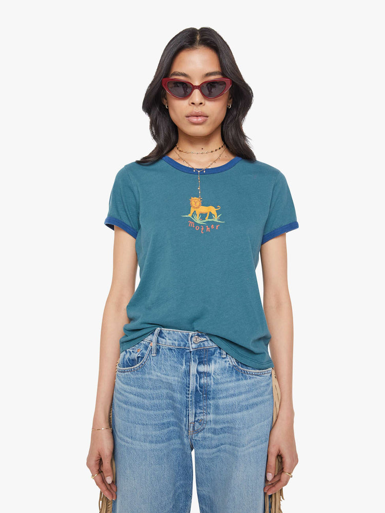 Front view of a woman in tee with extra-short sleeves and a slightly shrunken fit in a dark green with navy trim, the tee features a hand-drawn lion graphic and MOTHER's name in orange on the front.