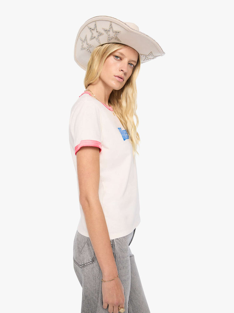 Side view of a woman in a white tee with sun-faded red trim extra-short sleeves and a slightly shrunken fit with a flocked MOTHER graphic across the chest.