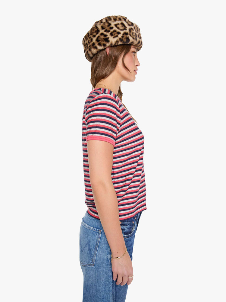Side view of a woman in a hot pink, navy and glittery silver horizontal stripes tee with extra-short sleeves.
