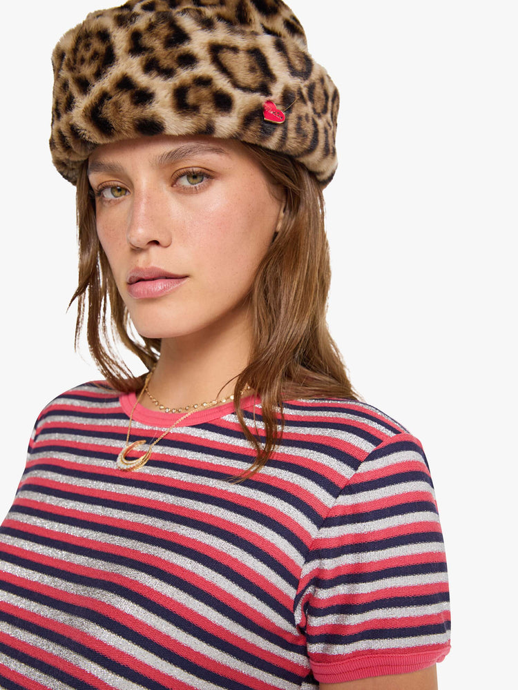 Close up view of a woman in a hot pink, navy and glittery silver horizontal stripes tee with extra-short sleeves.