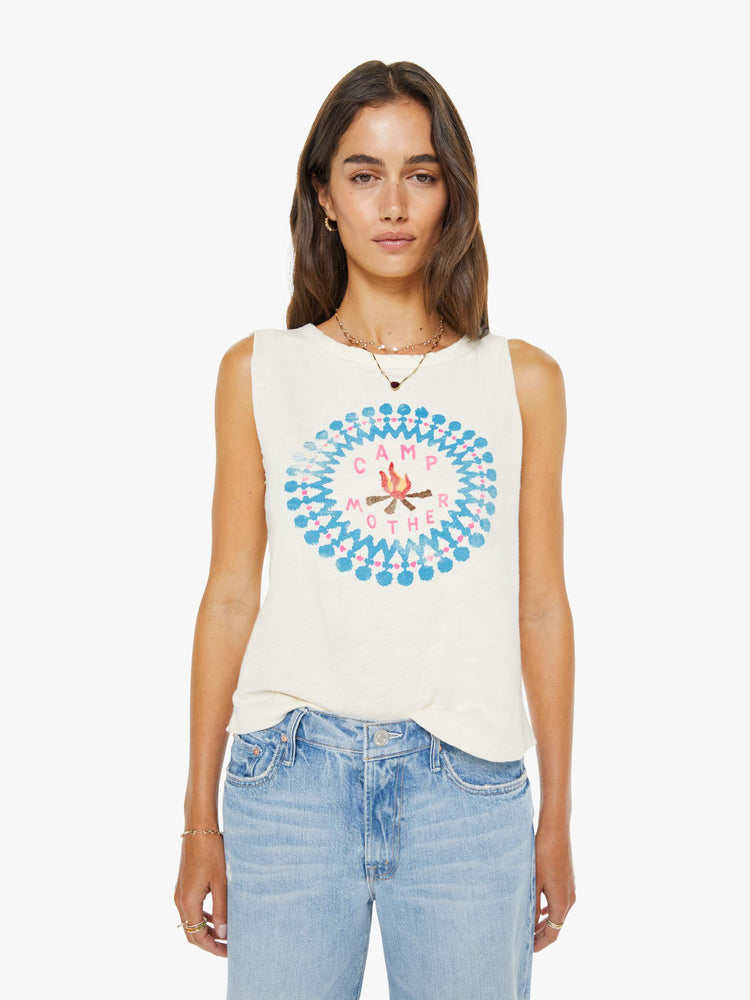 Front view of a woman in an off-white top features a campfire graphic with text in pink on the front cut off sleeveless top.