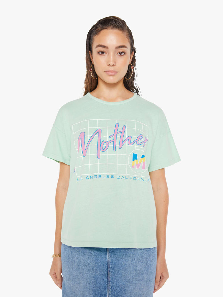 Front view of a woman wearing a light teal crew neck tee with an oversized fit, featuring a retro inspired graphic that reads "Mother".