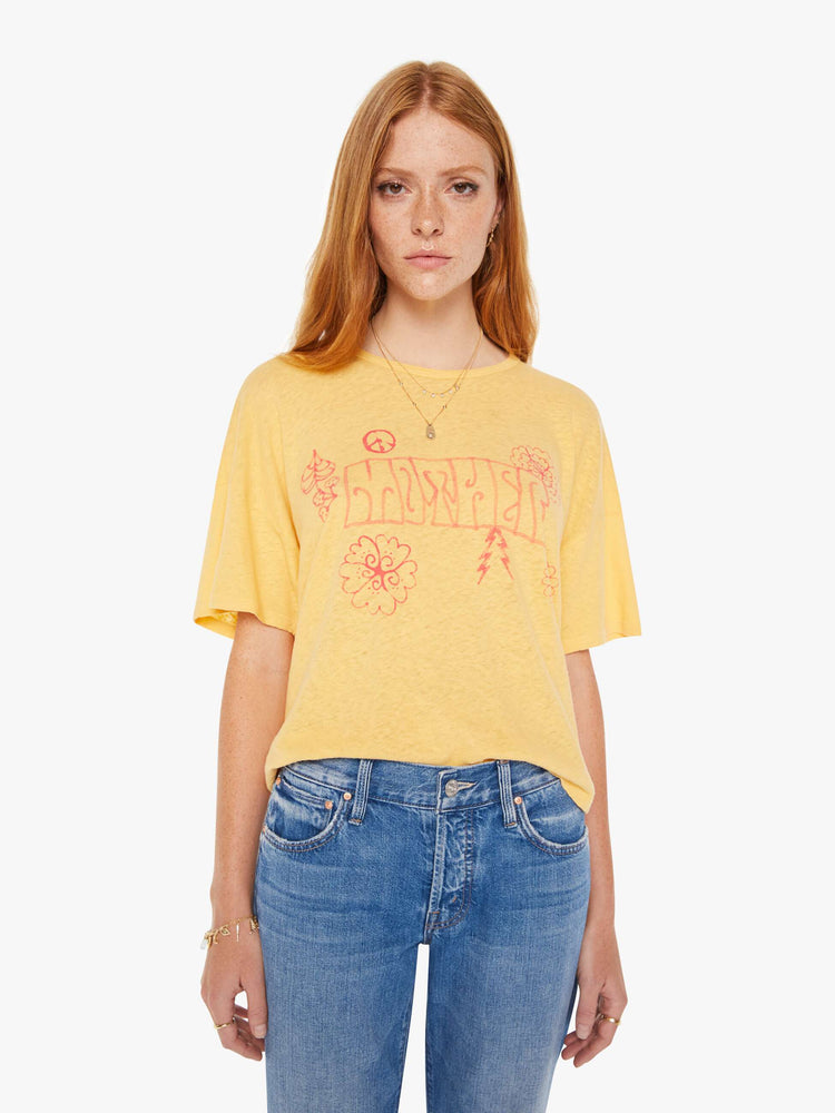 Front view of a womens yellow crew neck tee featuring an oversized fit and a pink graphic reading "MOTHER".