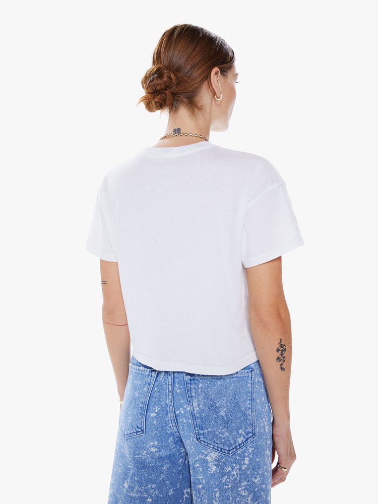 Back view of a woman crewneck tee with drop shoulders, a cropped hem and a boxy fit in a white hue with colorful tourist graphic.