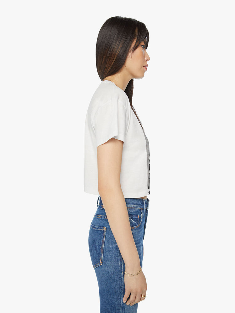 Side view of a woman oversized crewneck tee with drop shoulders, a cropped hem and a boxy fit in white, the tee features a graphic fox in black on the front.