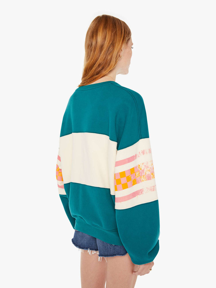 Back view of a womens oversized crew neck sweatshirt in teal featuring a striped graphic reading "MOTHER".
