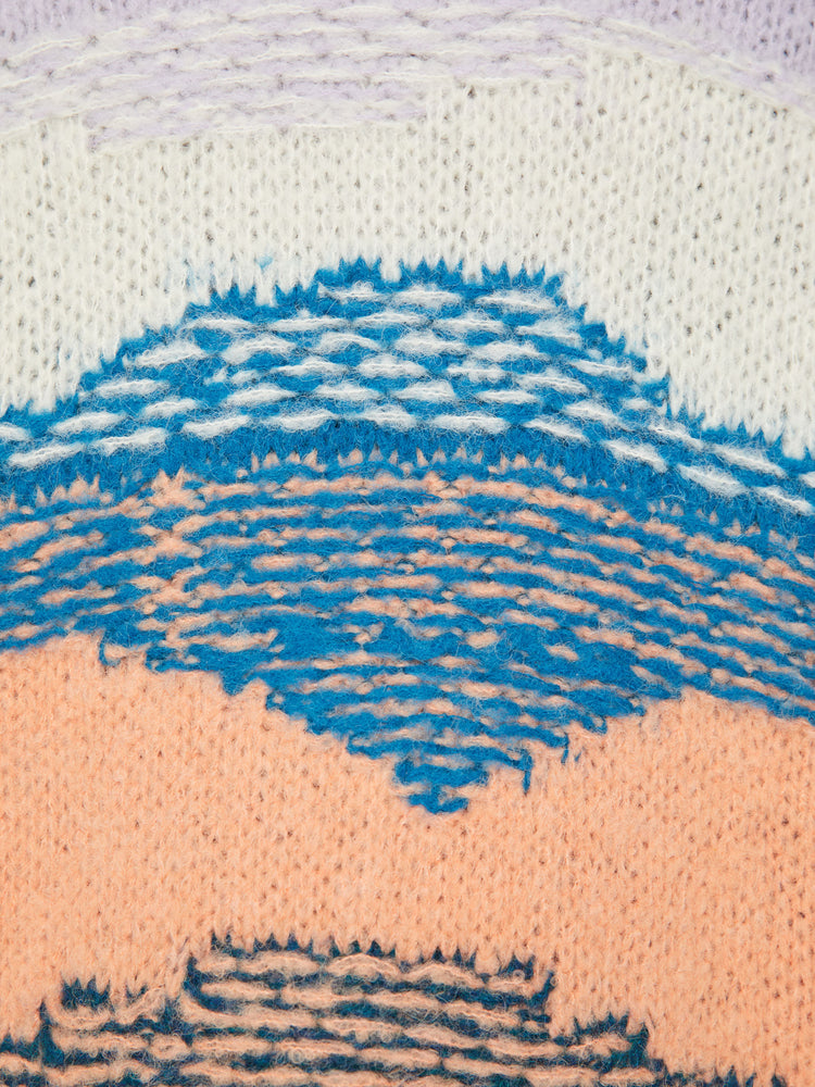 Swatch view of a woman oversized cardigan with a V-neck, drop shoulders, buttons down the front and ribbed hems in shades of orange, navy, lavender and blue, and is designed with reverse stitching for texture.