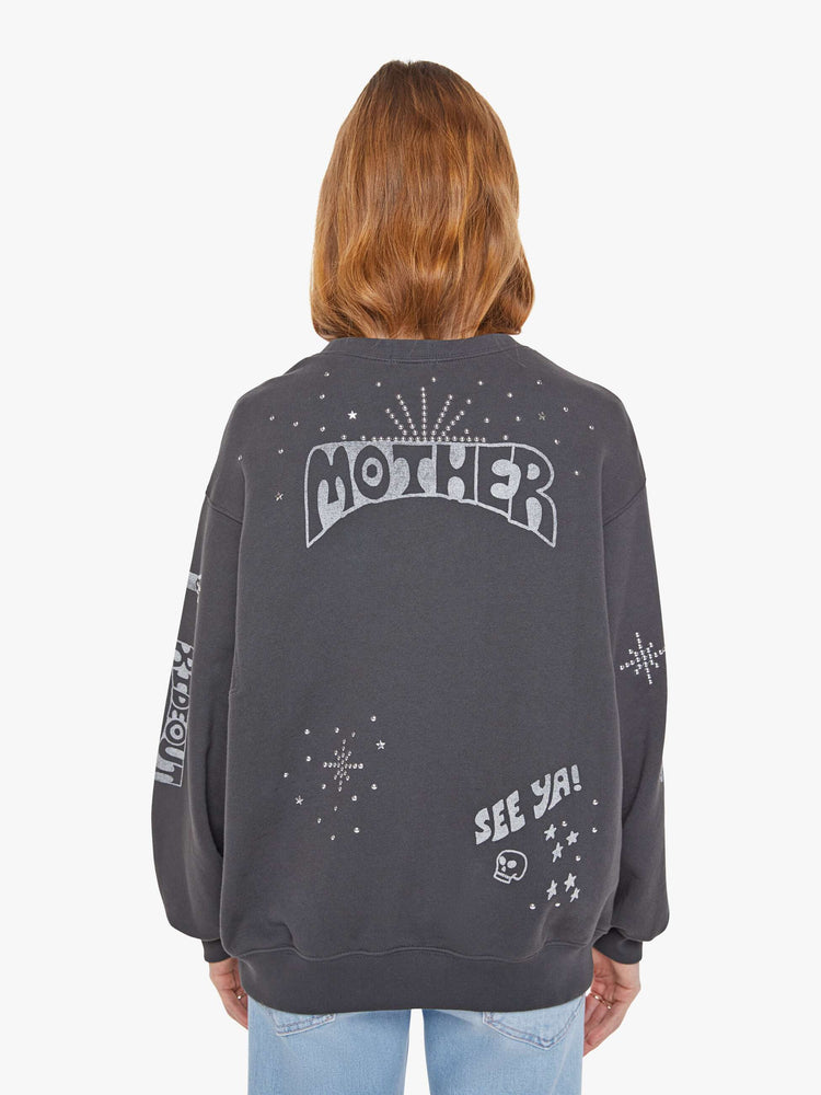 Back view of a woman in a faded black oversized sweatshirt with a crewneck, drop shoulders, inset balloon sleeves and a relaxed fit