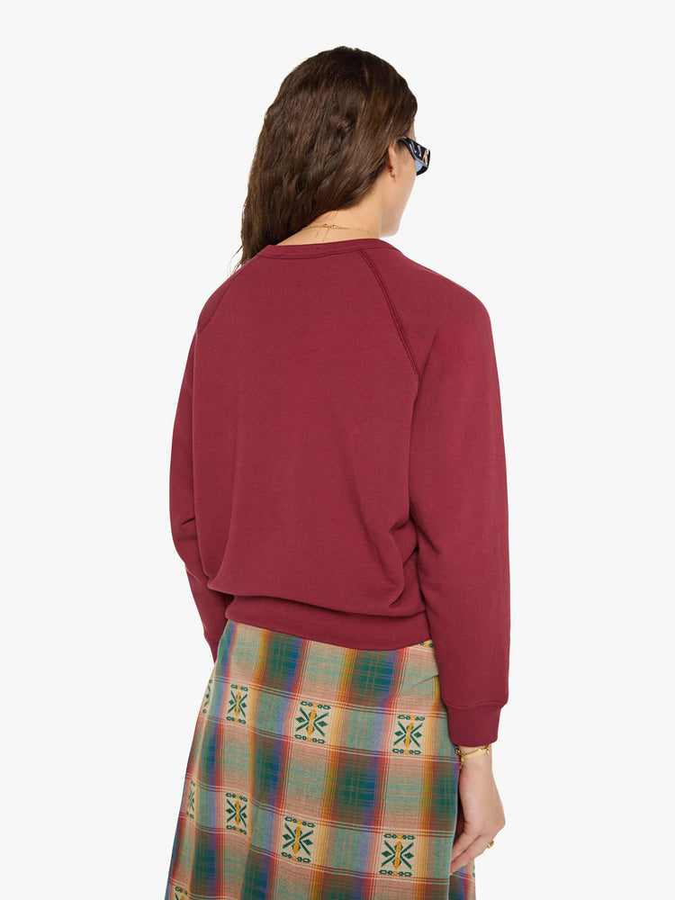 Back view of a woman in a maroon with MOTHER's name in cream and a pastel eagle graphic in fuzzy puff print sweater.