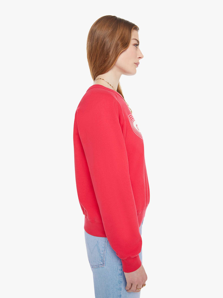 Side view in a woman in a crewneck sweatshirt in red with a white text graphic and MOTHER's name on the front.