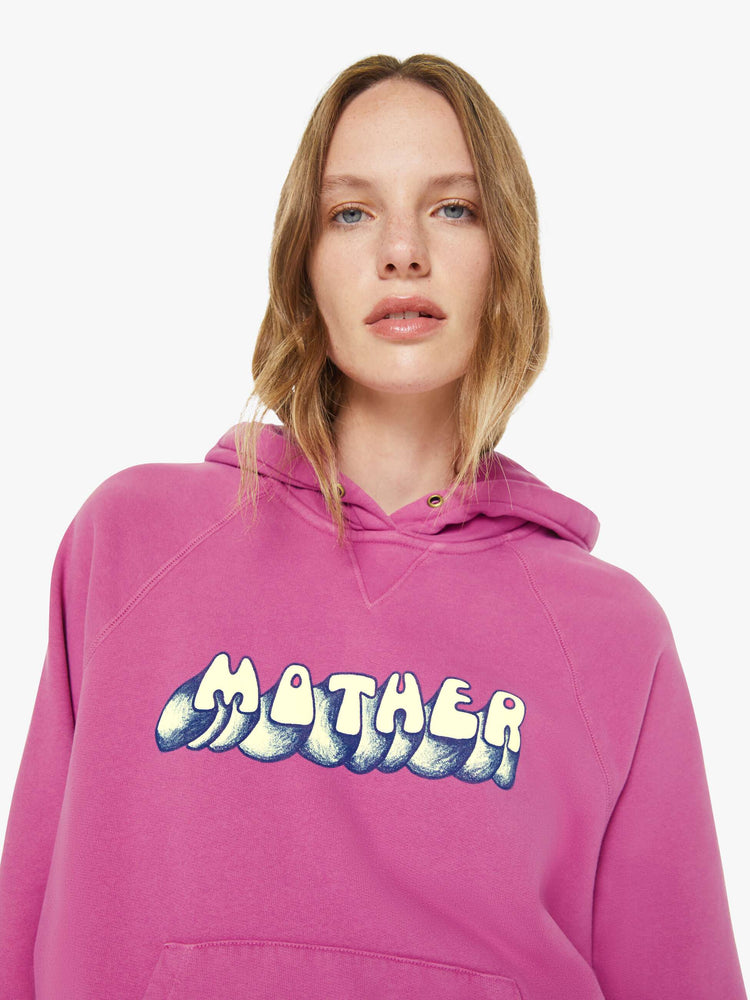 Close up view of a woman in faded purple sweater with MOTHER's name in white and navy printed on the front.