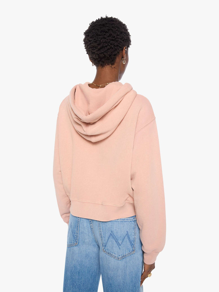Back view of a woman in a light pink with colorful scarf drawstring hoodie with drop shoulders, ribbed hems and a front patch pocket.