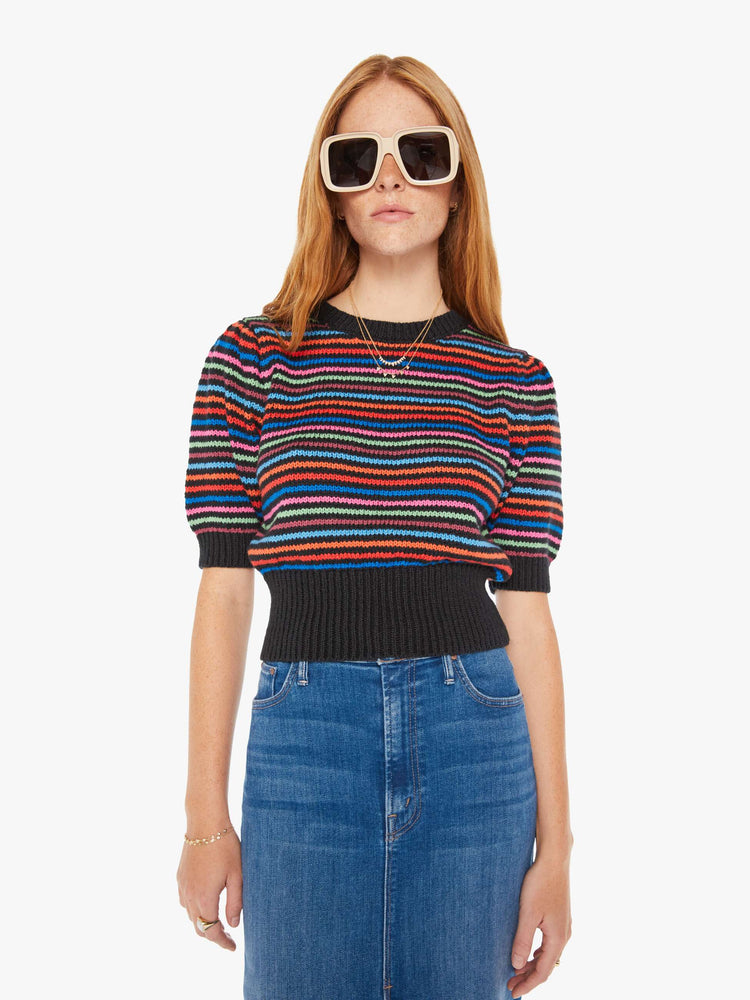 Front view of a woman knit top with a crew neck, elbow-length balloon sleeves and a thick ribbed hem in black with neon stripes.