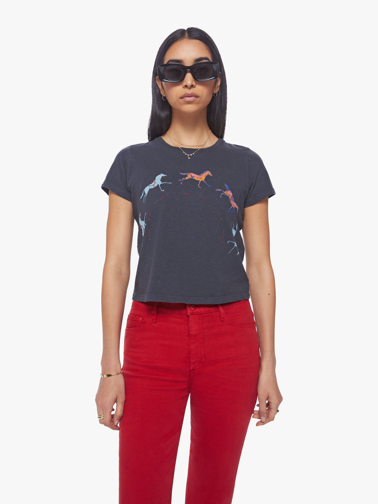 Front view of a woman  faded black tee features horse graphics across the chest crewneck.