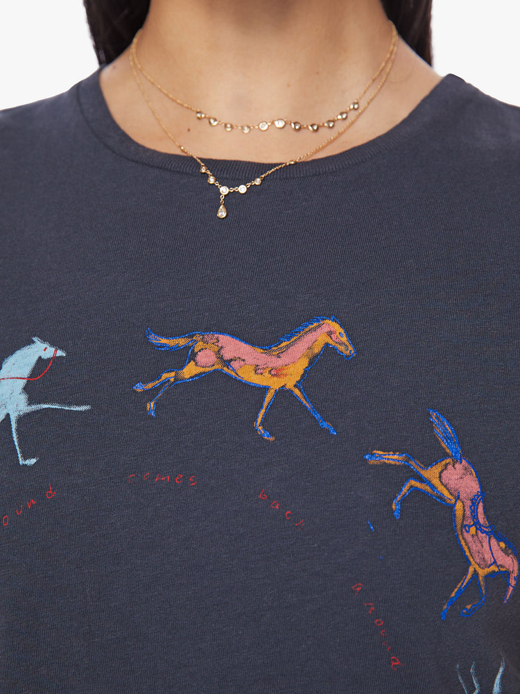 Close up view of a woman faded black tee features horse graphics across the chest crewneck.