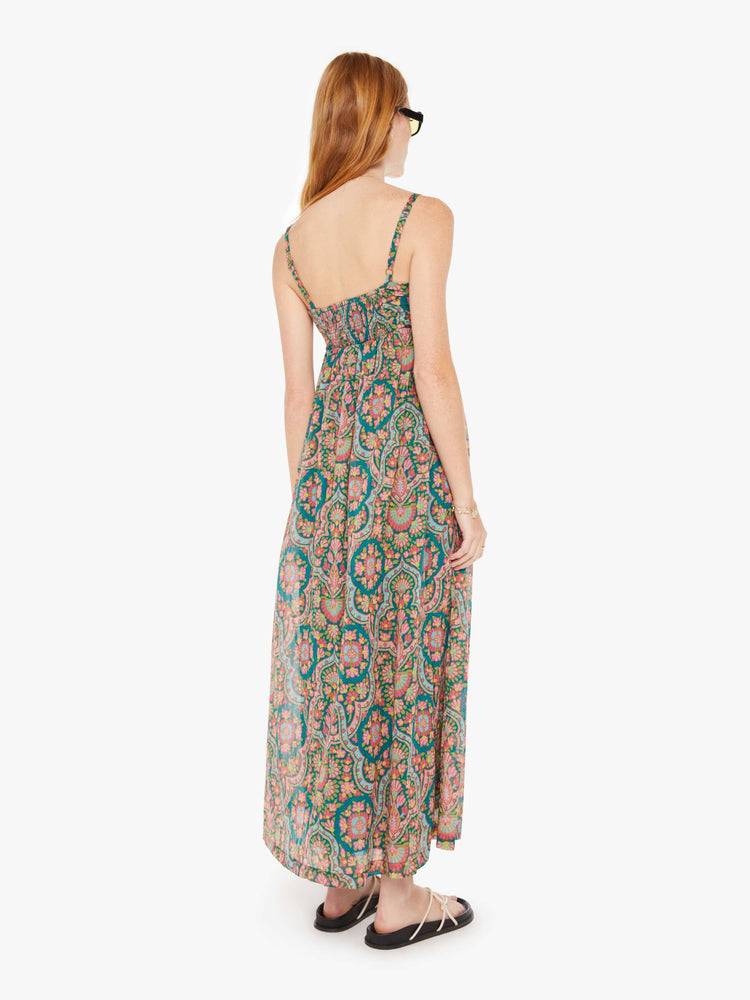 Back view of a womens long dress featuring a rug inspired colorful print.