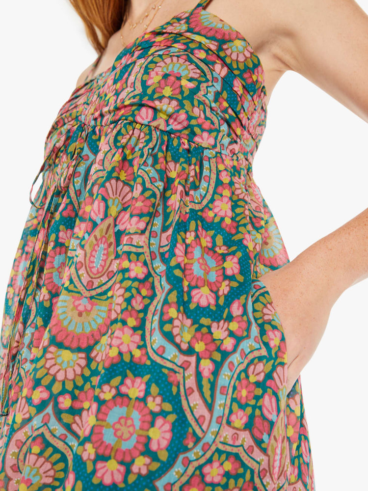 Side close up view of a womens long dress featuring a rug inspired colorful print.