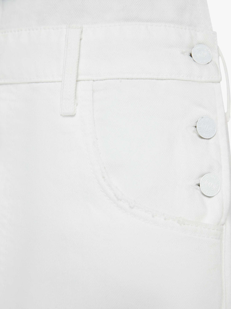 Swatch view of a woman in a white overalls with a front patch pocket, adjustable straps, a wide leg, knee-length inseam and a frayed hem.