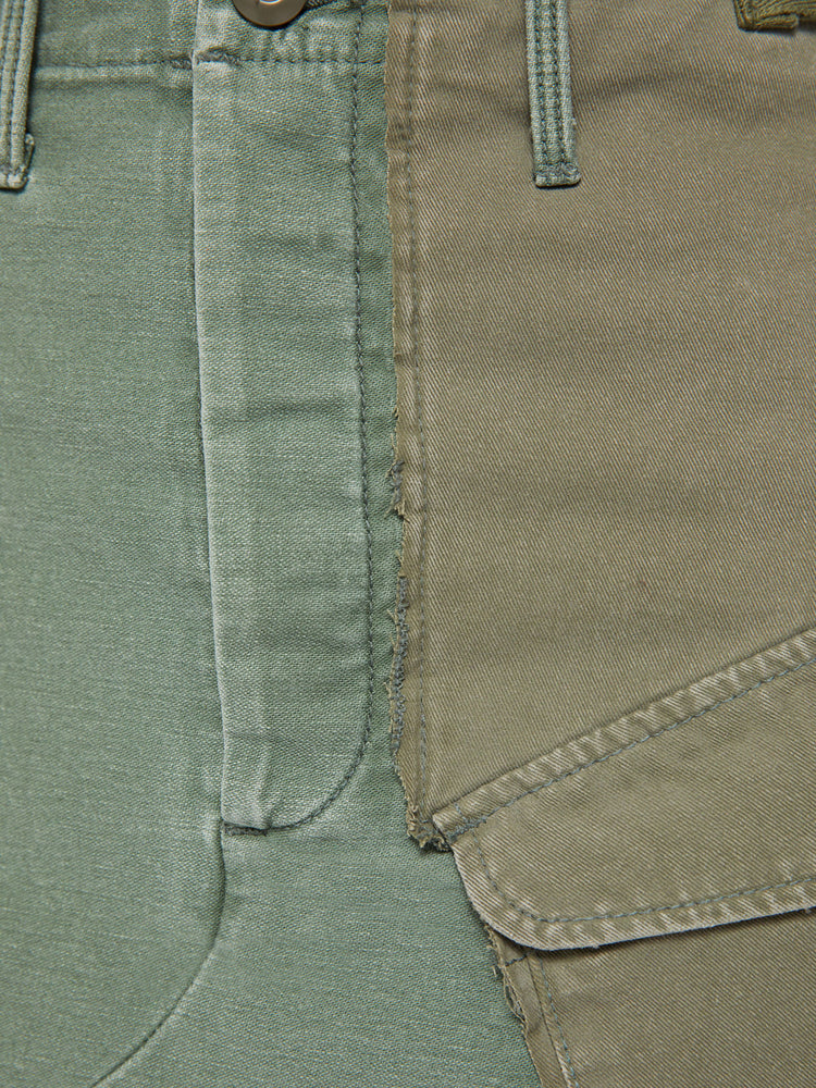 Swatch view of a woman argo mini skirt with a high rise, patch pockets and a slightly pointed hem in an army-green hue with pockets made from deadstock fabric.