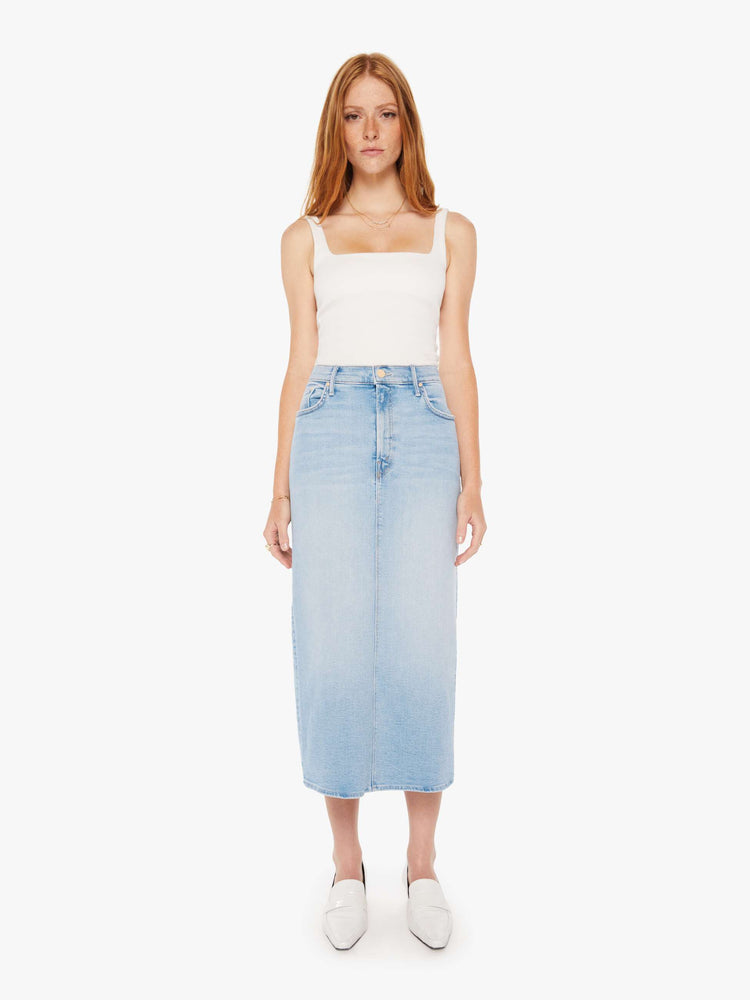 Front view of a woman light blue denim pencil skirt with a high rise, narrow fit and a thigh-high back slit.
