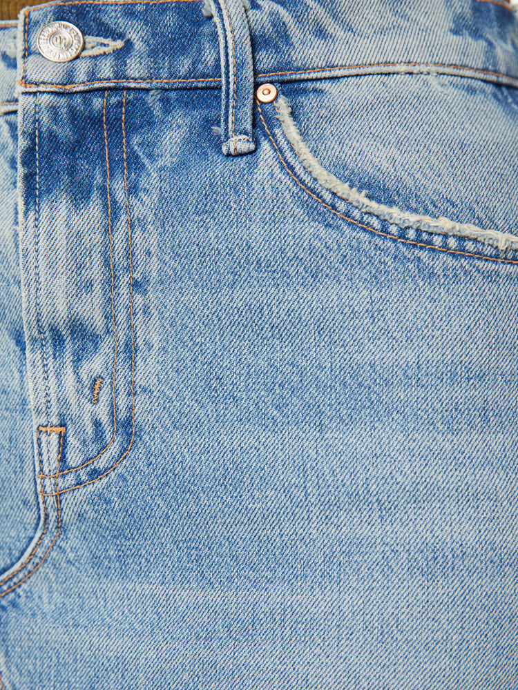 Swatch view of a woman denim maxi skirt with a super-high front slit, dramatically frayed hems and a relaxed fit in a light blue wash.