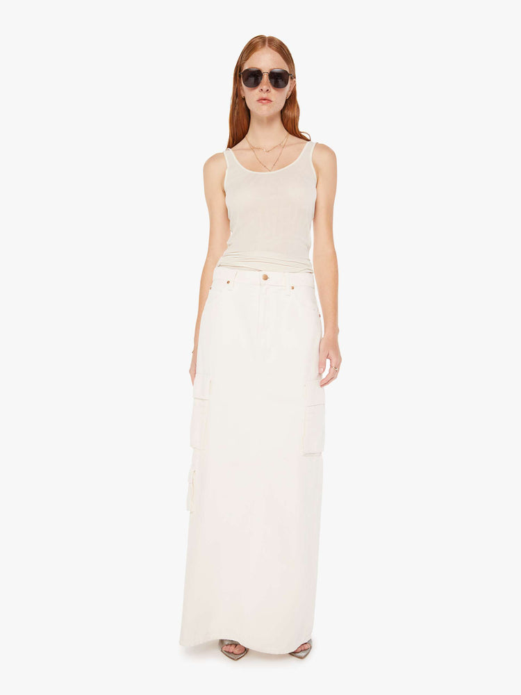 Front view of a womens off white denim skirt featuring a slouchy mid rise, cargo pockets, and a full length clean hem.