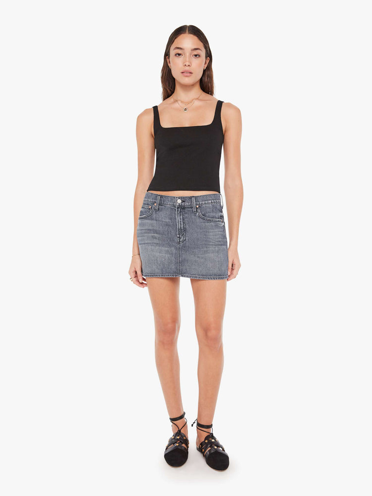Front view of a womens grey denim skirt featuring a relaxed mid rise and clean hem.