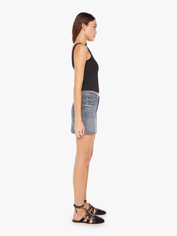 Side view of a womens grey denim skirt featuring a relaxed mid rise and clean hem.