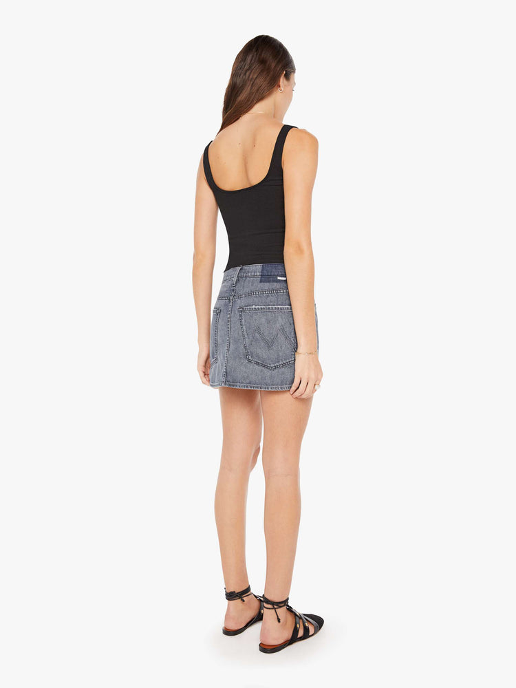 Back view of a womens grey denim skirt featuring a relaxed mid rise and clean hem.