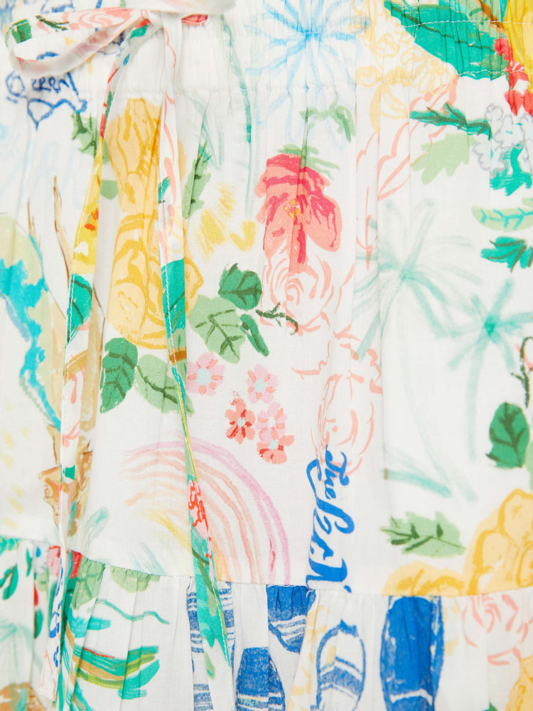 Swatch view of a woman in a white midi skirt with an elastic drawstring waistband and a ruffled tier with hand-drawn doodles throughout and blue stitching at the hem.