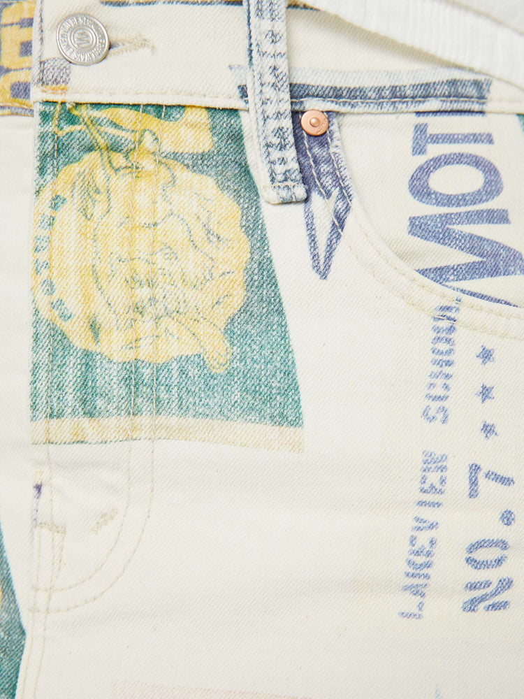 Swatch view of a woman in an off-white with a faded pennant print throughout low-slung mini skirt with a zip fly and a raw, frayed hem.