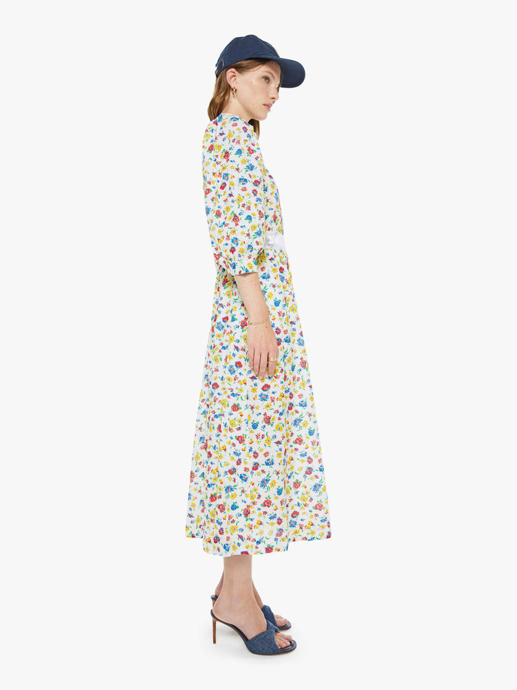 Side view of floral colorful print flowy maxi dress with a wide V-neck, 3/4-length sleeves and a loose fit.