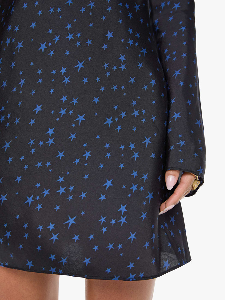 Swatch view of a woman wearing  a bias-cut mini dress with a wide crewneck, long sleeves, a thigh-length hem and a pull-on, zipless design. 