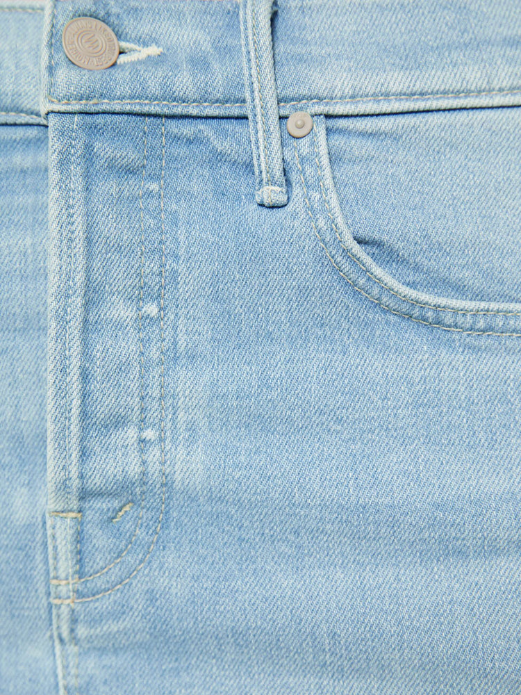 Swatch view of a woman in light blue a low-slung mini skirt with a button fly and a raw, frayed hem.
