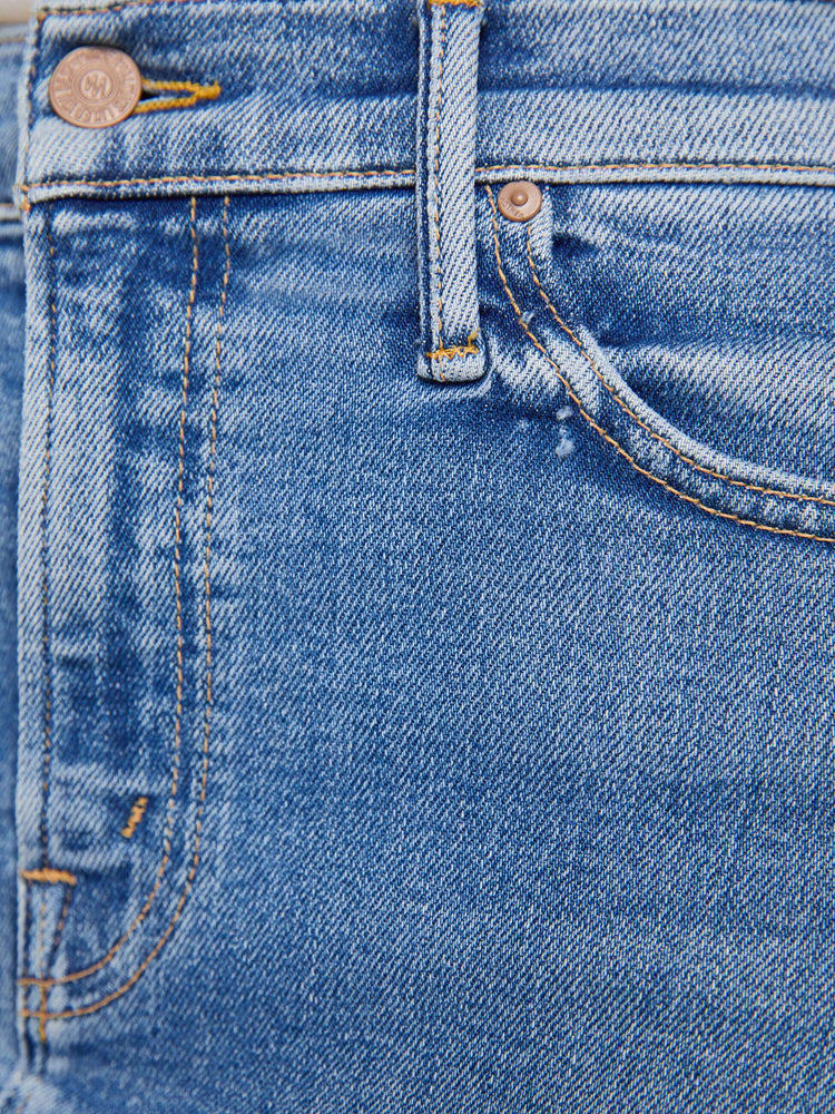 Swatch view of a woman in med blue denim midi skirt with a zip fly and an A-line fit.