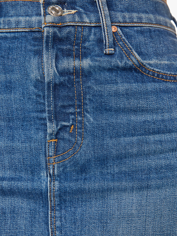Swatch view of a woman denim midi skirt with a knee-length hem and a slouchy fit designed to sit lower on the hips in a classic blue wash.